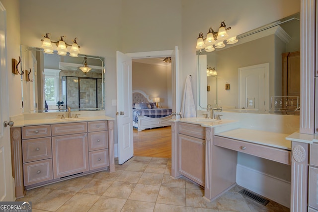 bathroom with two vanities, ensuite bath, a stall shower, and tile patterned floors
