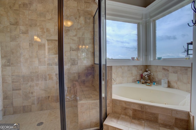 full bath featuring a shower stall and a tub with jets