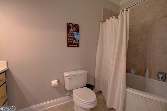 full bath featuring vanity, tile patterned flooring, toilet, baseboards, and tiled shower / bath