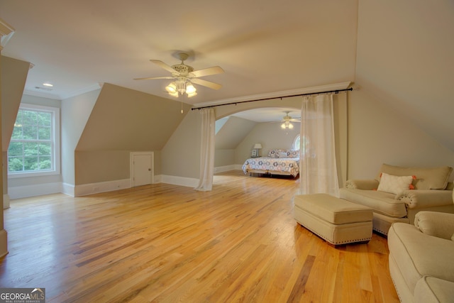 additional living space with ceiling fan, light wood-type flooring, lofted ceiling, and baseboards