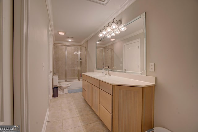 full bath featuring crown molding, tile patterned flooring, toilet, vanity, and combined bath / shower with glass door
