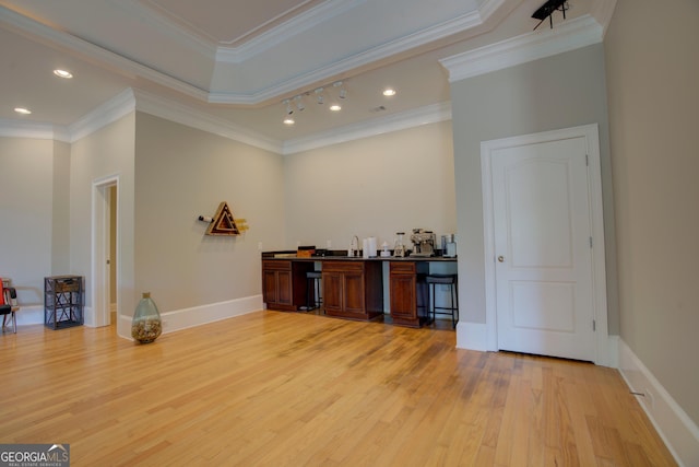 indoor wet bar with light wood finished floors, ornamental molding, recessed lighting, and baseboards