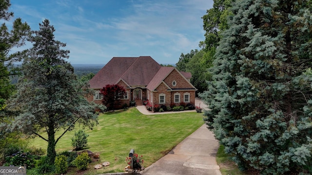 view of front facade featuring a front yard and brick siding