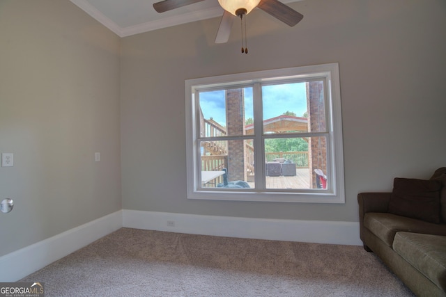 living room featuring carpet, ornamental molding, baseboards, and a ceiling fan