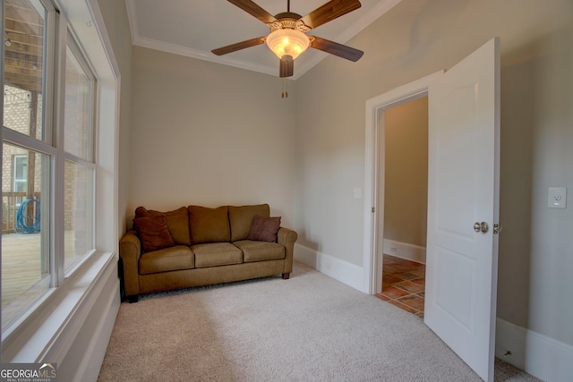 living room with carpet floors, crown molding, a ceiling fan, and baseboards