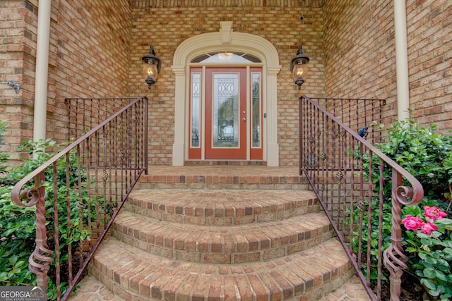 property entrance featuring brick siding and a porch
