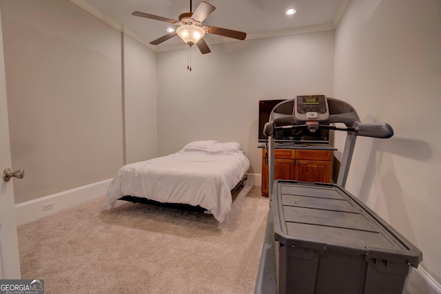 carpeted bedroom with ornamental molding, ceiling fan, and baseboards