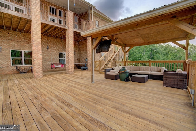 wooden deck featuring an outdoor living space and stairway