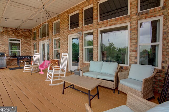 wooden terrace featuring a porch and an outdoor living space