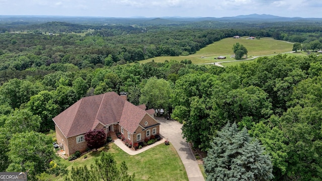 view of subject property with a heavily wooded area