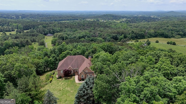 view from above of property with a heavily wooded area