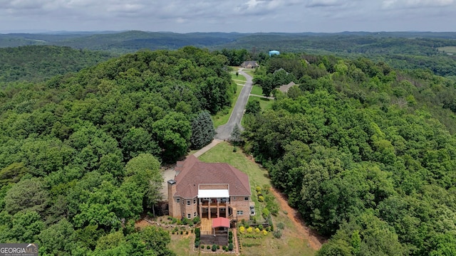 view from above of property featuring a heavily wooded area