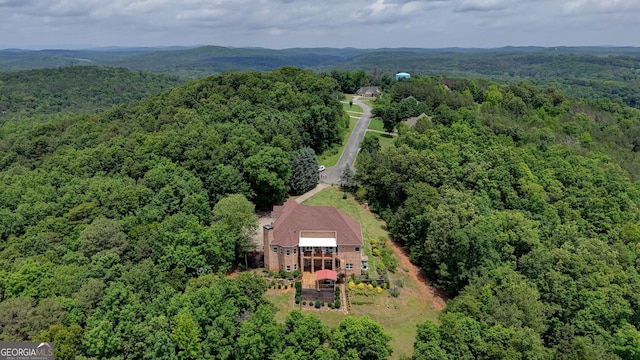 view from above of property featuring a heavily wooded area