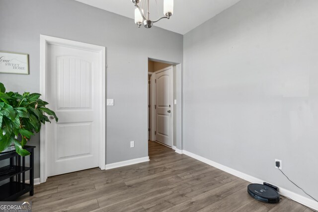 103 Olson Way, Kingsland, GA 31548 - unfurnished dining area featuring a chandelier, wood finished floors, and baseboards