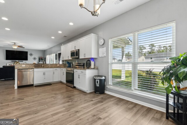 103 Olson Way, Kingsland, GA 31548 - kitchen featuring appliances with stainless steel finishes, open floor plan, a peninsula, a chandelier, and recessed lighting