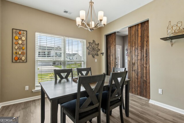 103 Olson Way, Kingsland, GA 31548 - dining area with a chandelier, wood finished floors, and baseboards