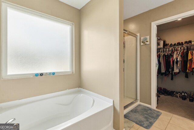 103 Olson Way, Kingsland, GA 31548 - full bathroom with a spacious closet, a shower stall, a bath, and tile patterned flooring