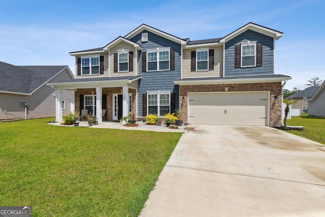103 Olson Way, Kingsland, GA 31548 - view of front of home featuring driveway, a garage, covered porch, and brick siding
