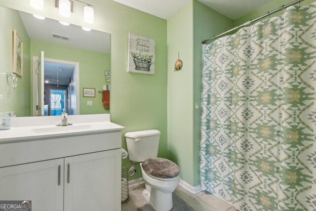 103 Olson Way, Kingsland, GA 31548 - bathroom featuring tile patterned floors, vanity, toilet, baseboards, and a shower with shower curtain