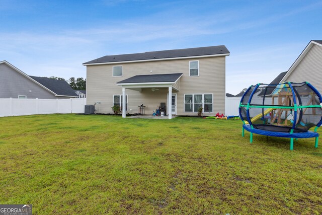 103 Olson Way, Kingsland, GA 31548 - rear view of property with a trampoline, a patio area, and central AC unit