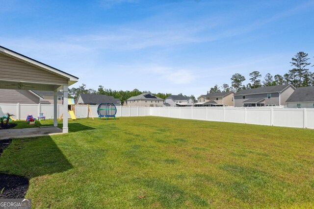 103 Olson Way, Kingsland, GA 31548 - view of yard featuring a trampoline, a playground, and a residential view
