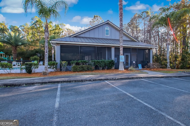 103 Olson Way, Kingsland, GA 31548 - farmhouse inspired home featuring a sunroom, uncovered parking, a standing seam roof, and board and batten siding