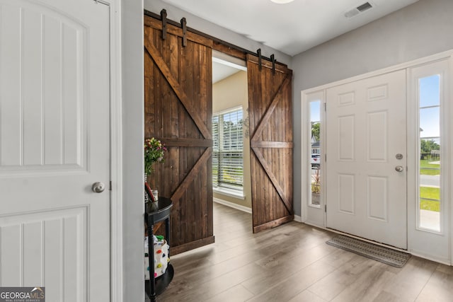 103 Olson Way, Kingsland, GA 31548 - foyer entrance with a barn door, wood finished floors, and baseboards