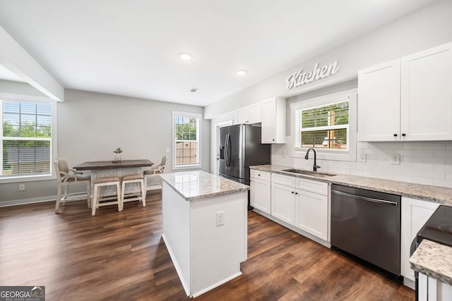 kitchen with stainless steel appliances, a sink, plenty of natural light, white cabinets, and recessed lighting