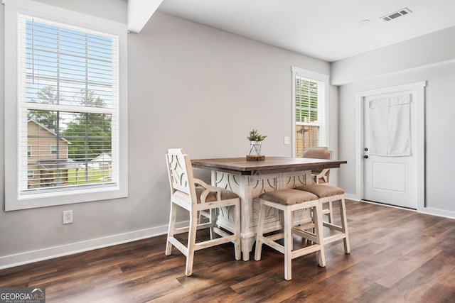 dining area with dark wood finished floors and baseboards