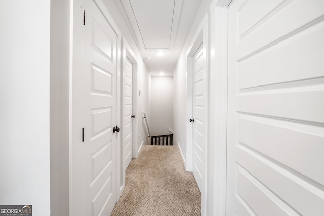 hallway with light carpet, attic access, and recessed lighting