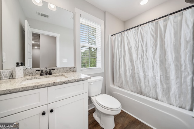 full bath with wood finished floors, toilet, vanity, and shower / tub combo with curtain