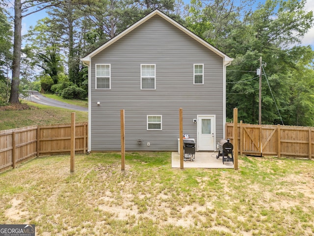 rear view of property featuring a patio and a gate