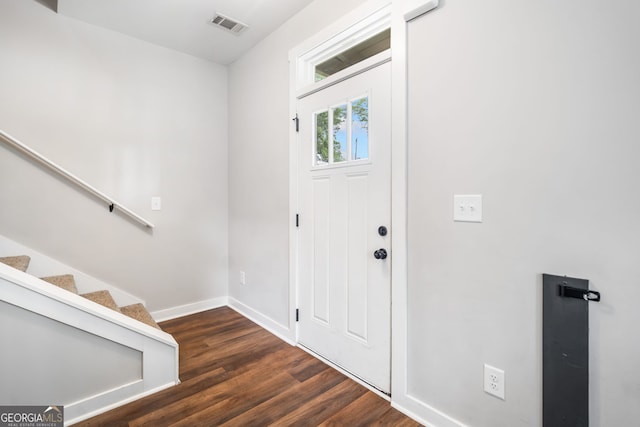 entryway with wood finished floors, baseboards, and stairs