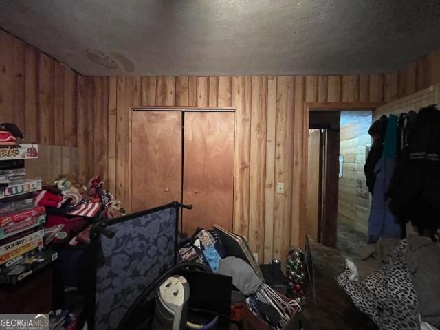 bedroom featuring wooden walls