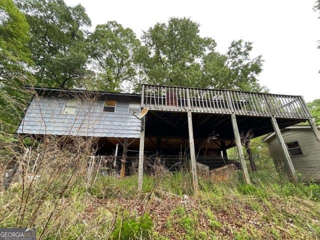 back of house featuring a deck
