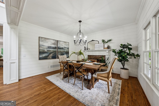 2195 Hickory Hill Rd, Alpharetta, GA 30004 - dining space with ornamental molding, a chandelier, wood finished floors, and wooden walls