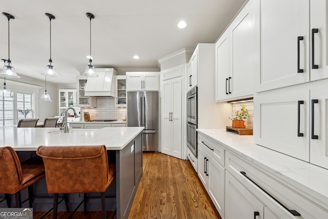 2195 Hickory Hill Rd, Alpharetta, GA 30004 - kitchen with appliances with stainless steel finishes, backsplash, a kitchen bar, white cabinetry, and glass insert cabinets