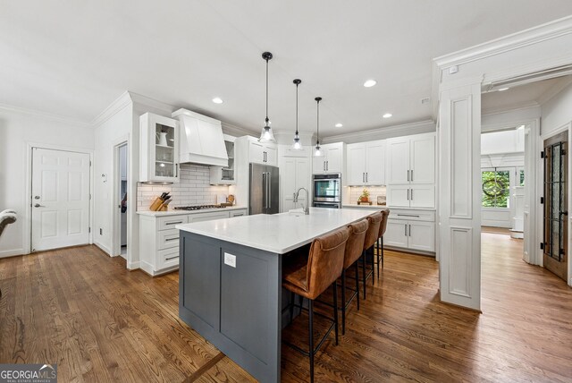 2195 Hickory Hill Rd, Alpharetta, GA 30004 - kitchen featuring stainless steel appliances, backsplash, custom range hood, a kitchen bar, and ornamental molding