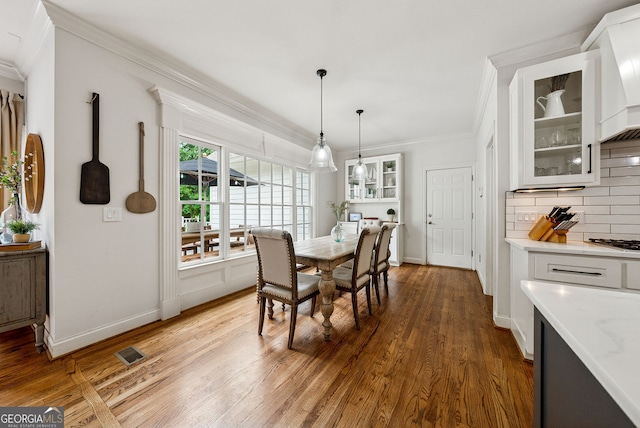 2195 Hickory Hill Rd, Alpharetta, GA 30004 - dining area with crown molding, wood finished floors, and baseboards