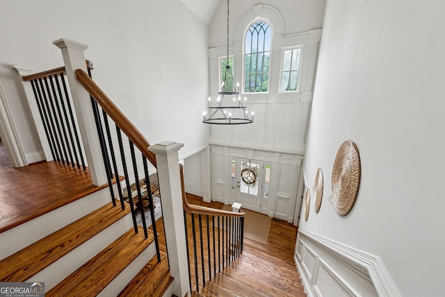 2195 Hickory Hill Rd, Alpharetta, GA 30004 - stairs featuring a chandelier, wood finished floors, and high vaulted ceiling