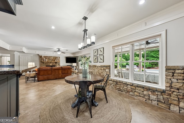 2195 Hickory Hill Rd, Alpharetta, GA 30004 - dining area featuring a fireplace, ceiling fan, ornamental molding, and a chandelier