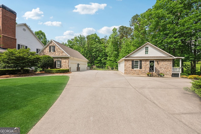 2195 Hickory Hill Rd, Alpharetta, GA 30004 - view of front facade with stone siding, a front yard, an outbuilding, and a detached garage