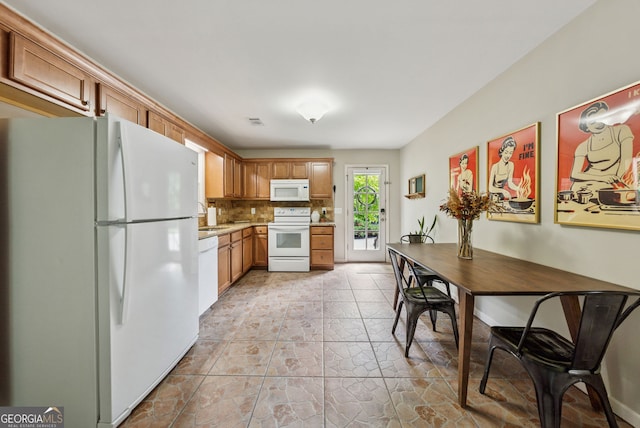 2195 Hickory Hill Rd, Alpharetta, GA 30004 - kitchen featuring white appliances, tasteful backsplash, light countertops, a sink, and brown cabinets