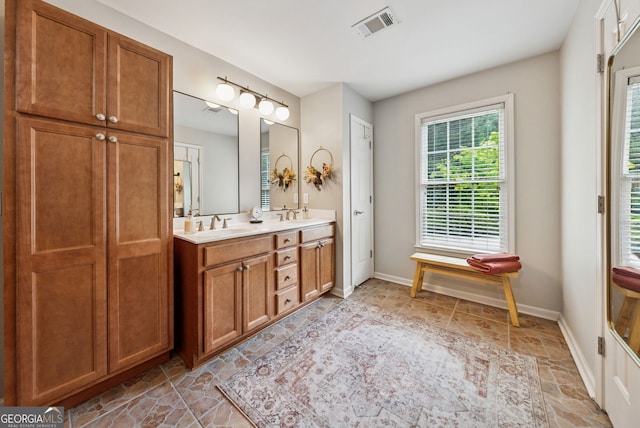 2195 Hickory Hill Rd, Alpharetta, GA 30004 - bathroom featuring double vanity, baseboards, and stone finish flooring