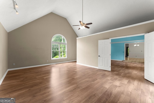 1713 Dudley Dr, Woodstock, GA 30188 - unfurnished living room featuring ceiling fan, wood finished floors, and lofted ceiling