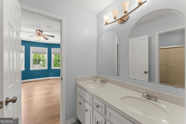 1713 Dudley Dr, Woodstock, GA 30188 - bathroom with double vanity, a ceiling fan, and wood finished floors