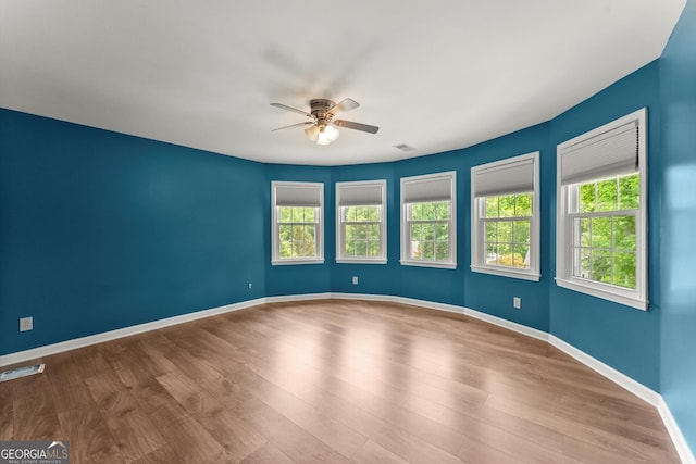 1713 Dudley Dr, Woodstock, GA 30188 - empty room featuring ceiling fan, healthy amount of natural light, and wood finished floors