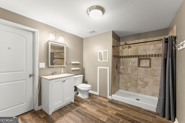 1713 Dudley Dr, Woodstock, GA 30188 - full bathroom featuring vanity, wood finished floors, and tiled shower