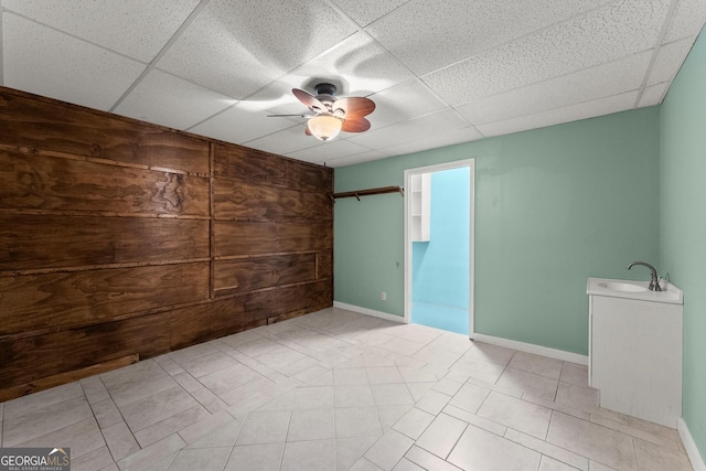 1713 Dudley Dr, Woodstock, GA 30188 - unfurnished bedroom featuring a paneled ceiling, a ceiling fan, and wooden walls