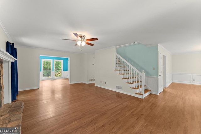 1713 Dudley Dr, Woodstock, GA 30188 - unfurnished living room featuring ornamental molding, stairway, light wood-style flooring, and ceiling fan